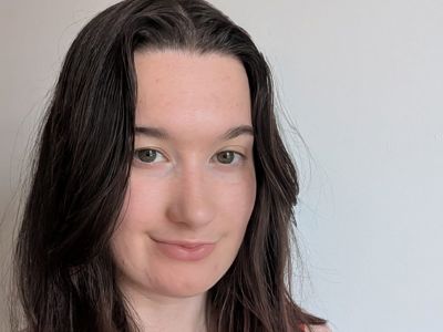 Aoife, a woman with brown hair and a red dress