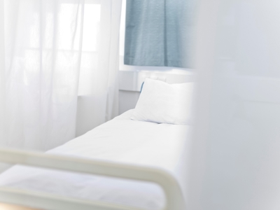 Soft focus hospital bed in brightly lit room