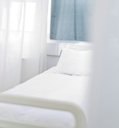 Soft focus hospital bed in brightly lit room