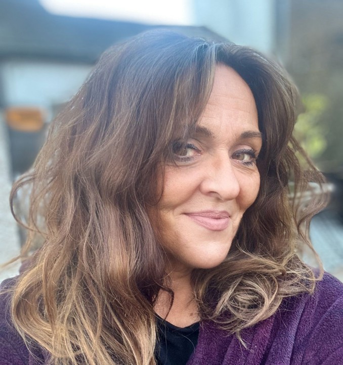 A woman with brown hair smiling