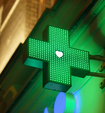 An LED green sign indicating a pharmacy