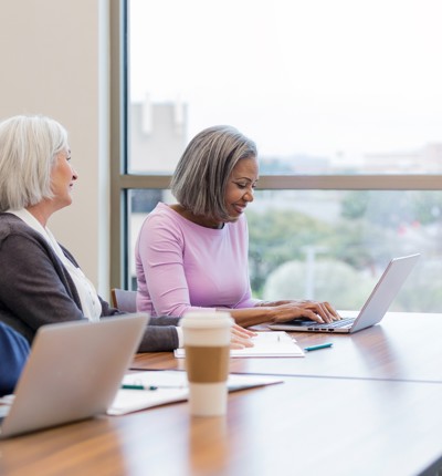 Two Women At Desk