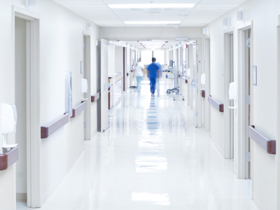 Doctor walking down hospital corridor 909214658