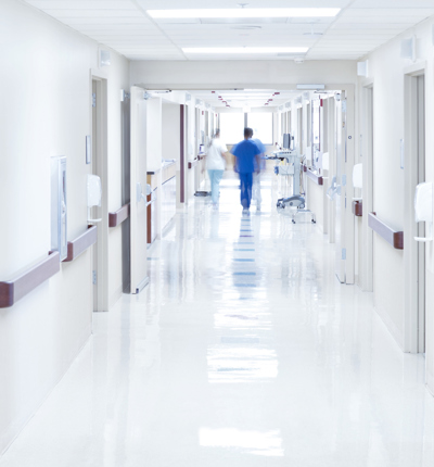 Doctor walking down hospital corridor 909214658