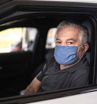 driver senior wearing protective medical mask