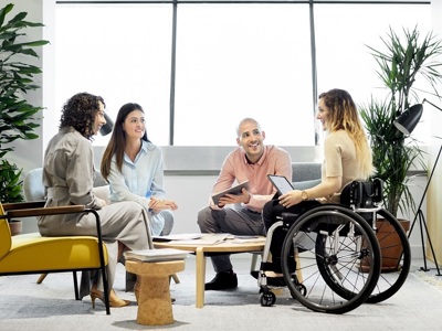 Young Female Wheelchair User In Group