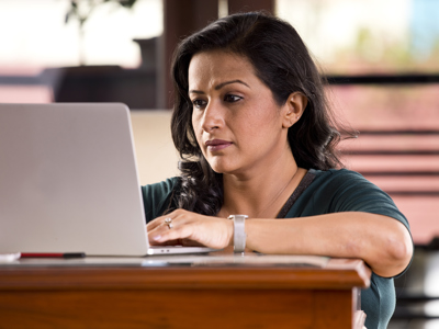 Seated woman looking at laptop