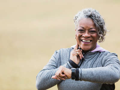 Senior woman exercising, taking pulse - Lower res