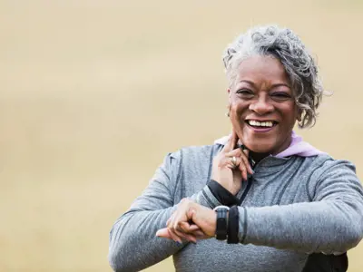 Senior woman exercising, taking pulse - Lower res