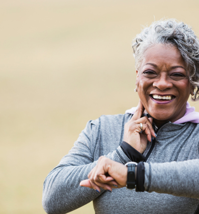 Senior woman exercising, taking pulse - Lower res