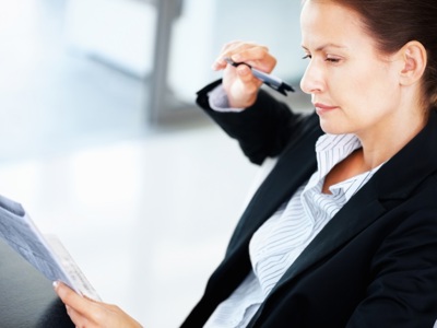 Business Woman Holding Pen + Papers