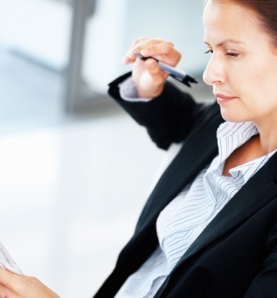 Business Woman Holding Pen + Papers