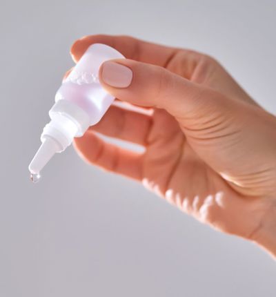 Person Holding Eyedrops