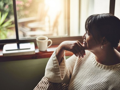 Woman With Drink Looking Out Of Window