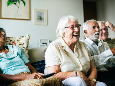 Four elderly people sat in a row