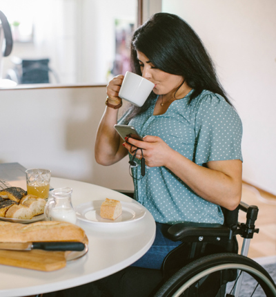 women in wheelchair working from home