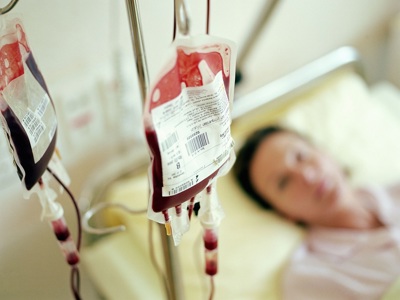 Blood bag, woman in hospital bed