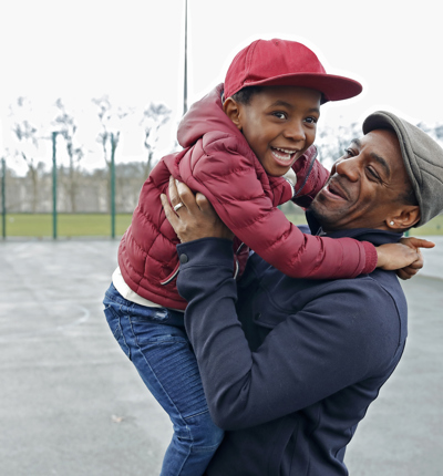 Father and son playing in park