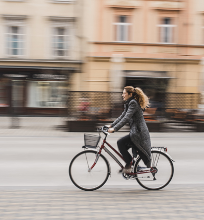 Woman cycling through city