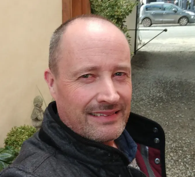 A man taking a selfie in his driveway