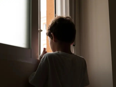 Boy Looking Out Of Window