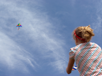 Young Teenage Girl Flying Kite