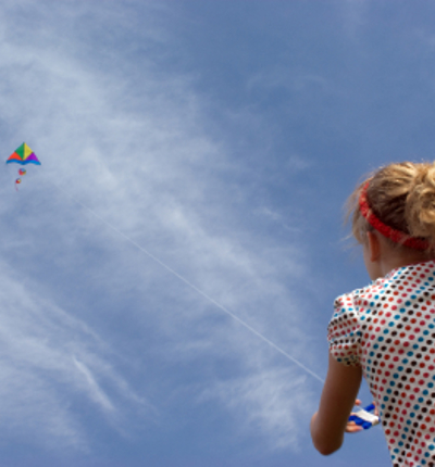 Young Teenage Girl Flying Kite