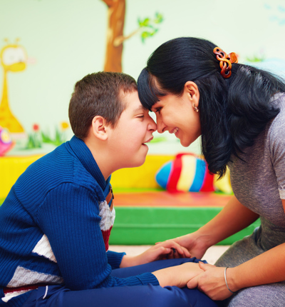 soulful moment. portrait of mother and her beloved son with disability in rehabilitation center