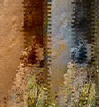 A sewage pipe leaking into brown water