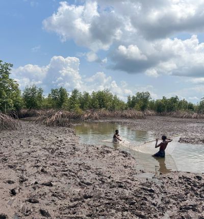 Members of Bodo community in a boat on waterway polluted by oil spills